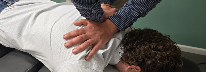 Chiropractor Grand Junction CO Ron Engler Dr. Ron Engler performing an adjustment on a patient's upper back